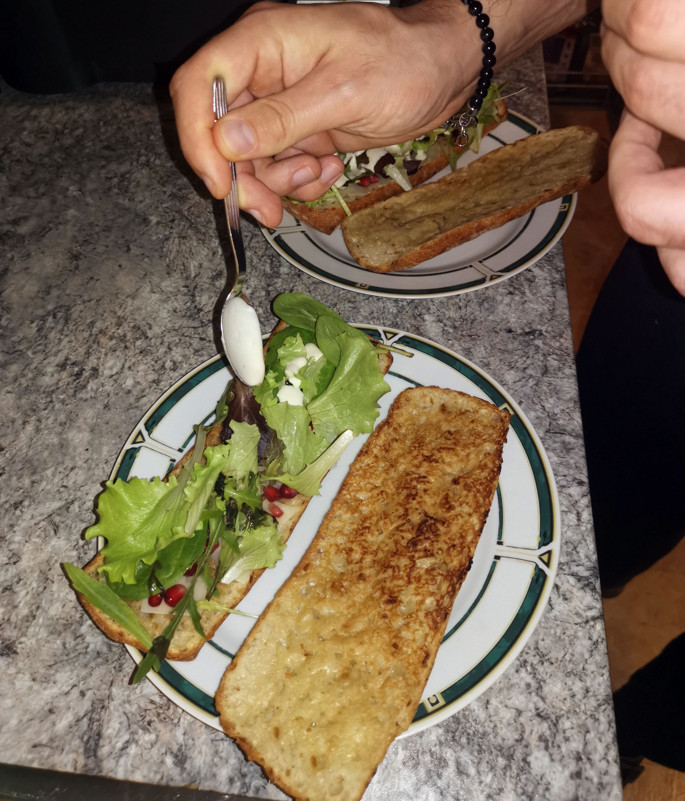 Filetsteak auf Zwiebelbaguette mit Caesar Salad und Granatapfelkernen
